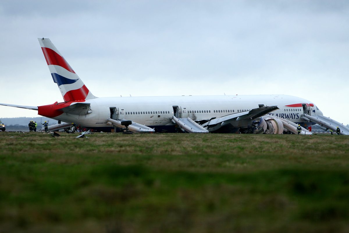 The damaged Boeing 777 G-YMMM resting on its belly short of runway 27L at London Heathrow.