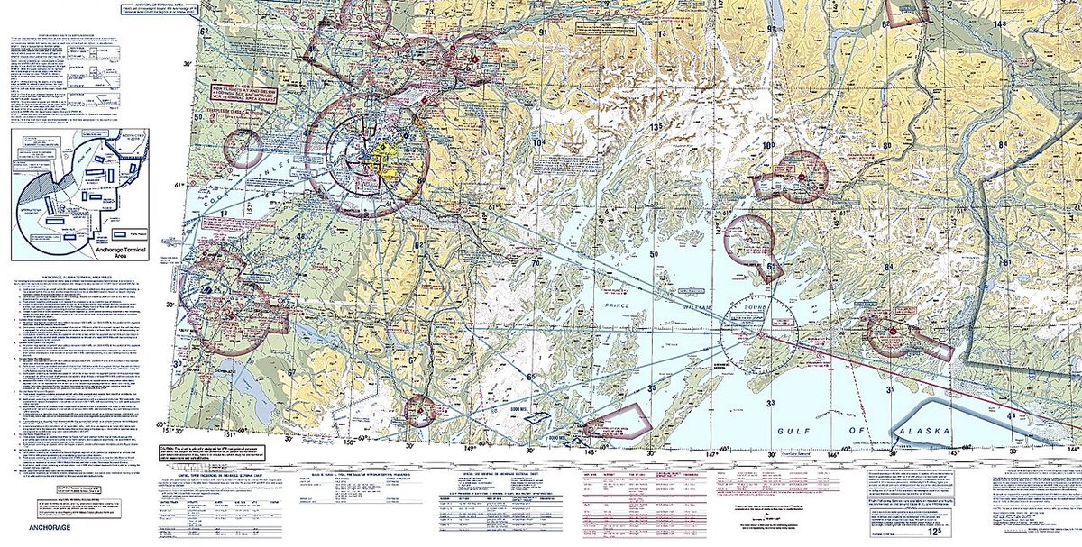 Part of an aeronautical chart showing coastline and terrain with blue and magenta airspace circles, airport symbols and a panel of legend text.