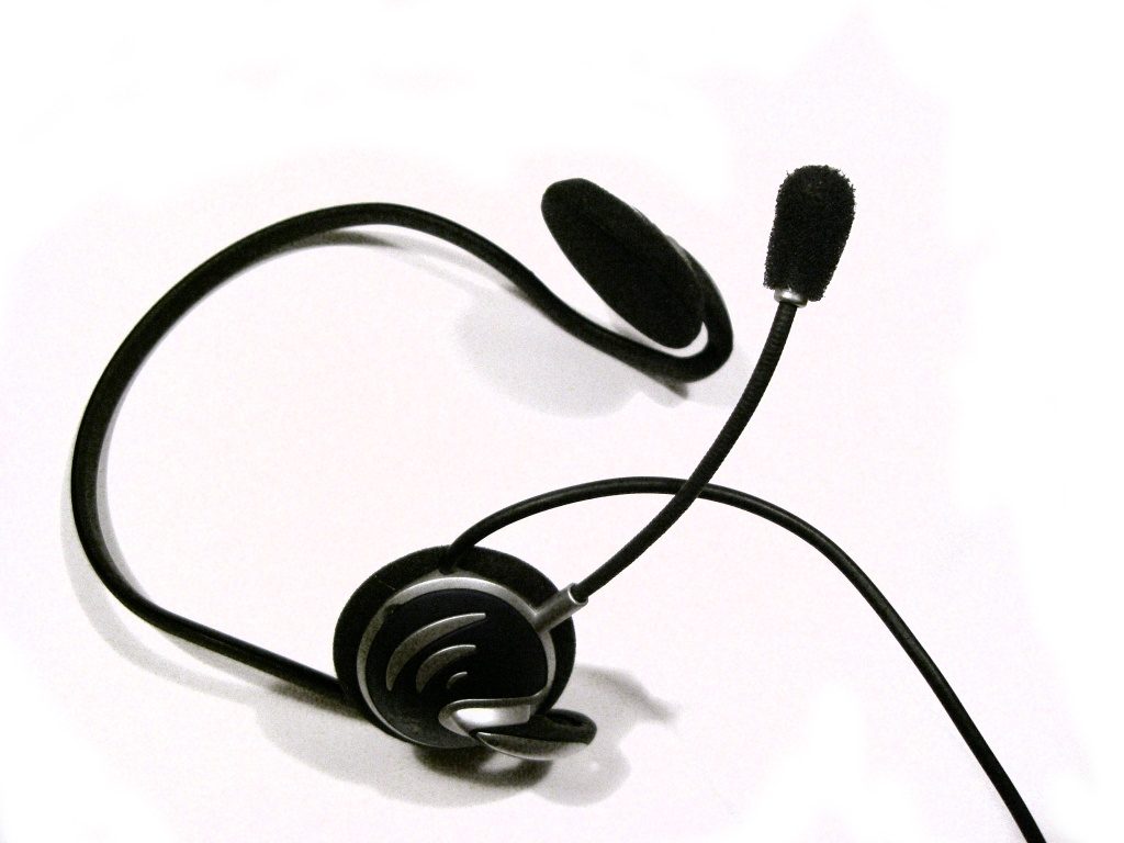 A pilot's headset with padded ear cups and a boom microphone on an adjustable arm.