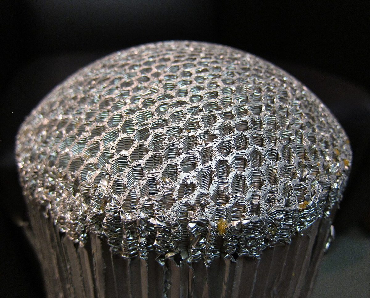 A piece of honeycomb core material made of many small hexagonal cells.