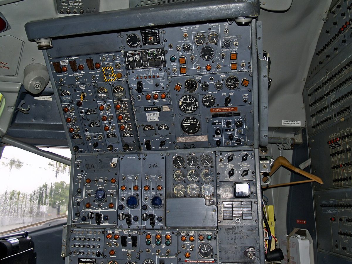 The flight engineer's station of a Boeing 727, a side-facing panel of gauges, switches and levers behind the pilots' seats.