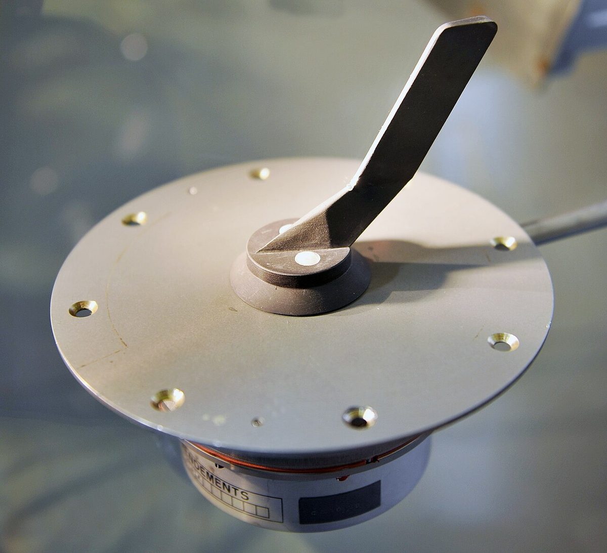 An aircraft angle of attack sensor unit with its vane, shown off the aircraft.