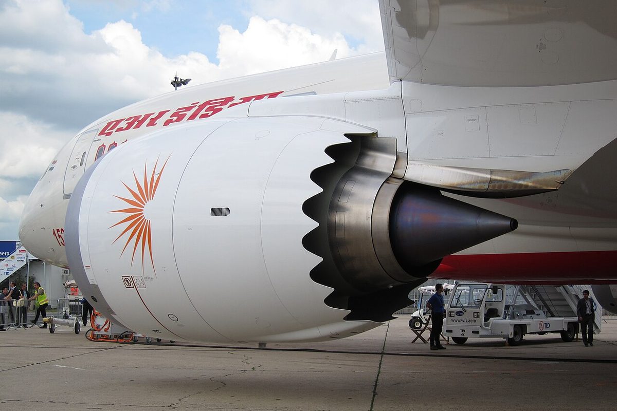The left engine of an Air India Boeing 787, a GE GEnx-1B, seen from the front quarter, with saw-tooth chevrons on the rear edge of the nacelle.