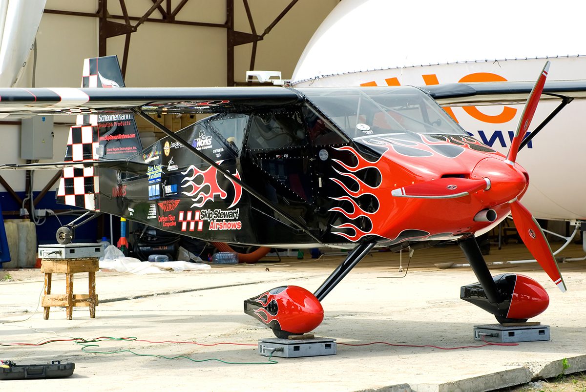 An aircraft standing on weighing scales in a hangar.