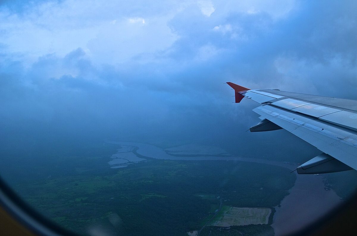 The Zuari river in Goa, India, winding through green country, seen from an airliner window beside the wing.