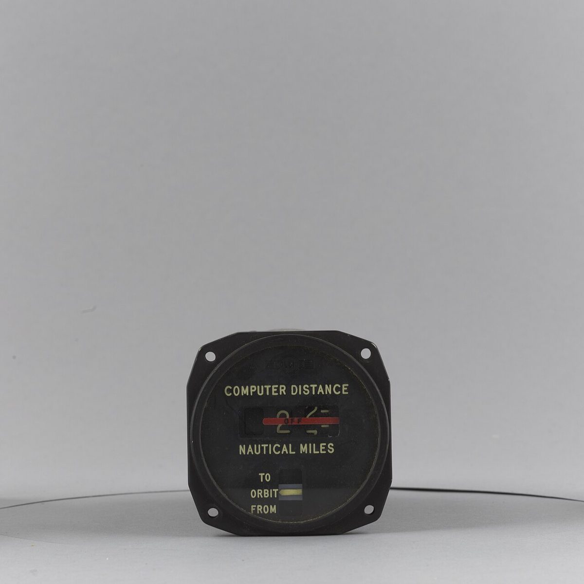 A round distance indicator from a museum collection, with a drum readout in nautical miles and a TO/FROM window.
