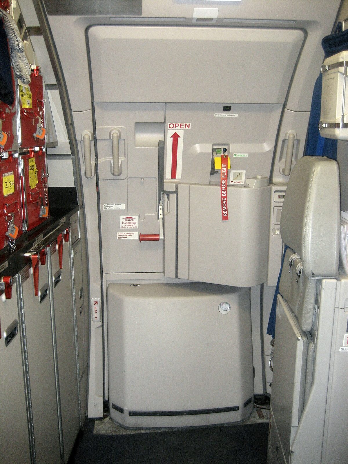 A passenger door of an Airbus A320 seen from inside the cabin.