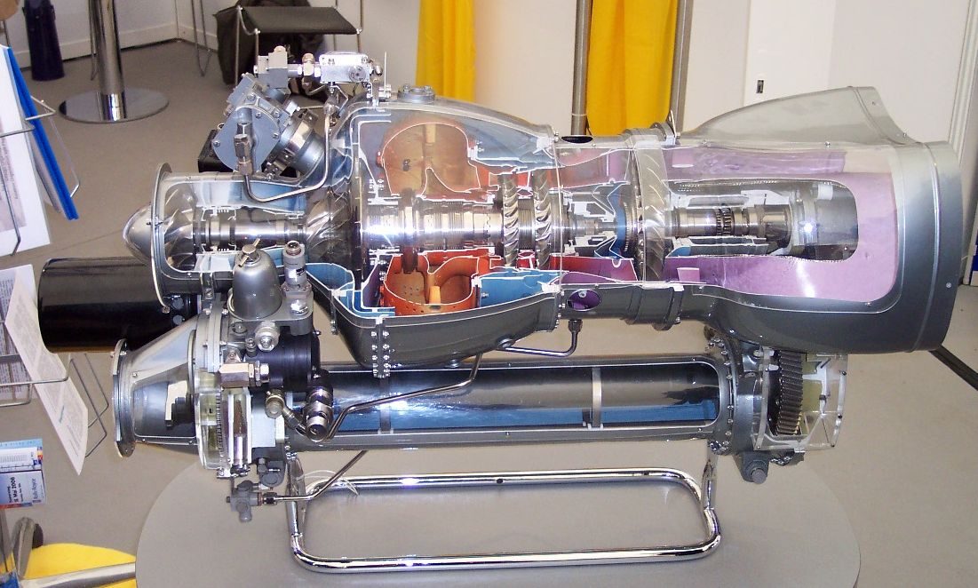 A sectioned helicopter turboshaft engine on display, showing its compressor, combustion chamber, turbines and output shaft.