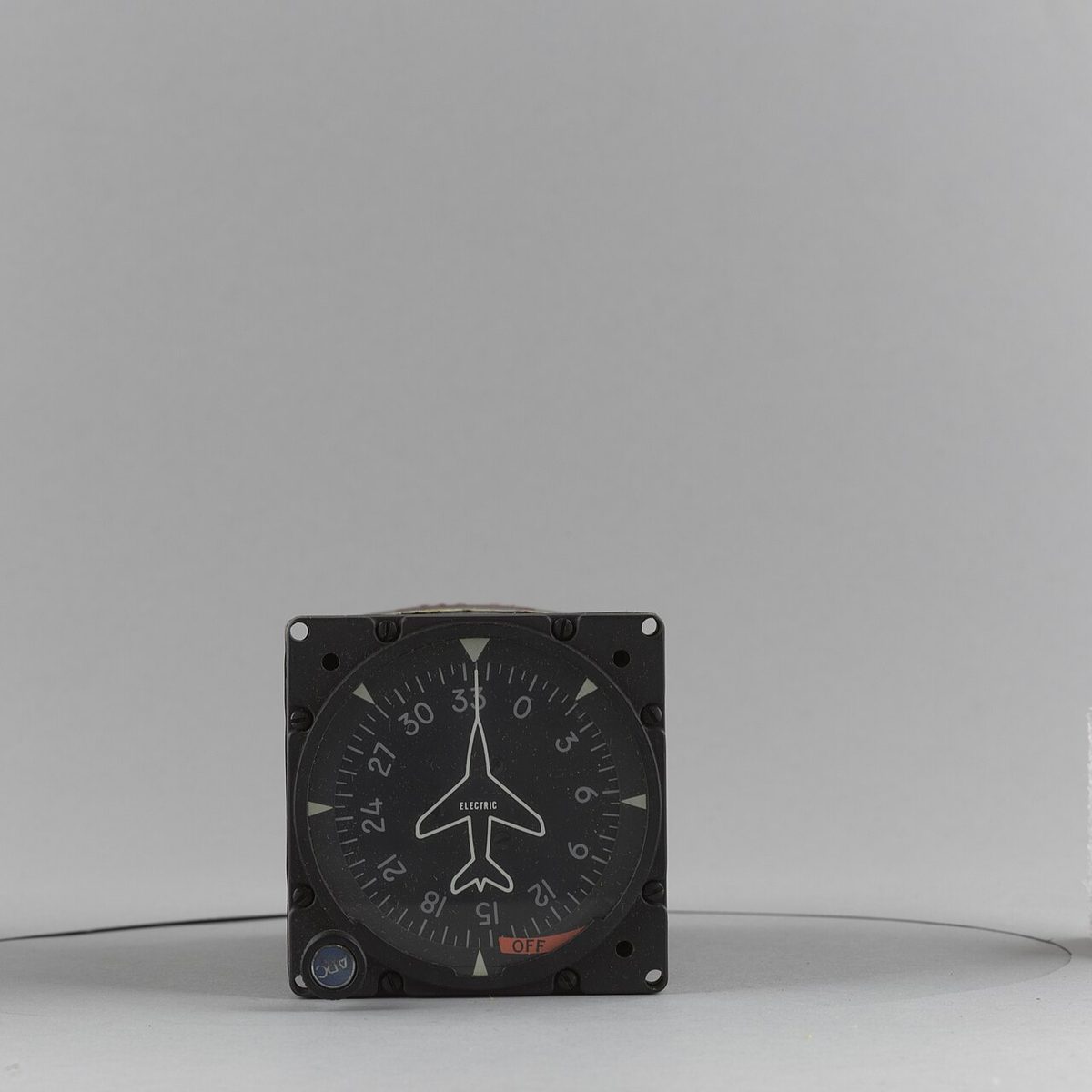 An electrically driven heading indicator: a compass card numbered every 30 degrees round a fixed aircraft symbol marked ELECTRIC, with a red OFF flag at the bottom and a knob at the bottom left.