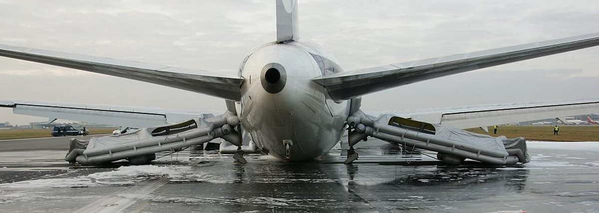 Inflated escape slides at the rear doors of the LOT Polish Airlines Boeing 767 that made a gear-up landing at Warsaw.