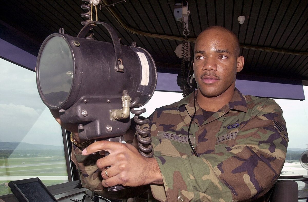 A US Air Force air traffic controller carrying out a maintenance check on a light gun.