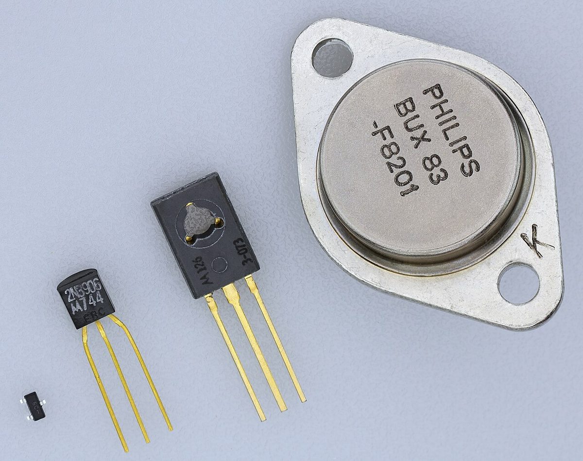 Several transistors in different packages, each with metal connecting leads.