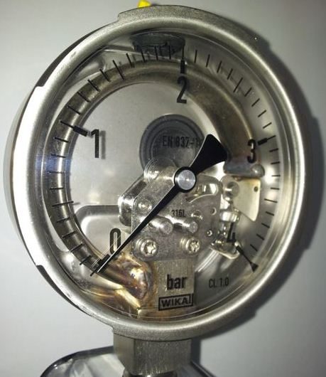 A Bourdon tube pressure gauge.