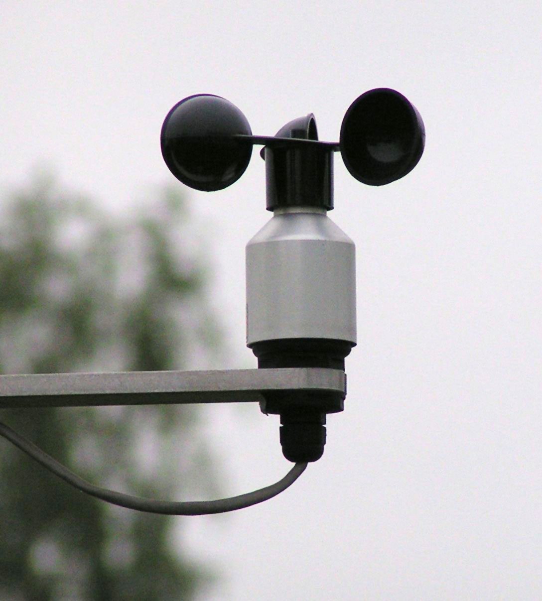 A three-cup anemometer on a horizontal mounting arm.