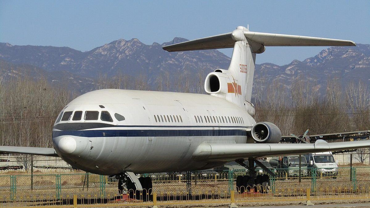 A three-engined jet airliner parked at a museum, with its engines grouped at the tail and the tailplane mounted on top of the fin.