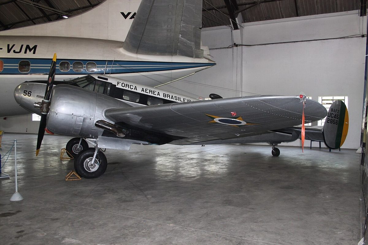 A Beechcraft Model 18, a twin-engined piston aircraft whose tailplane carries a separate fin and rudder at each tip.