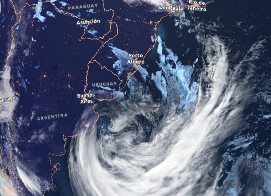 Satellite view of a large spiral of cloud around a mid-latitude low-pressure system over the ocean.