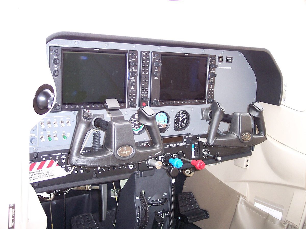 The instrument panel of a light aircraft fitted with large glass display screens.