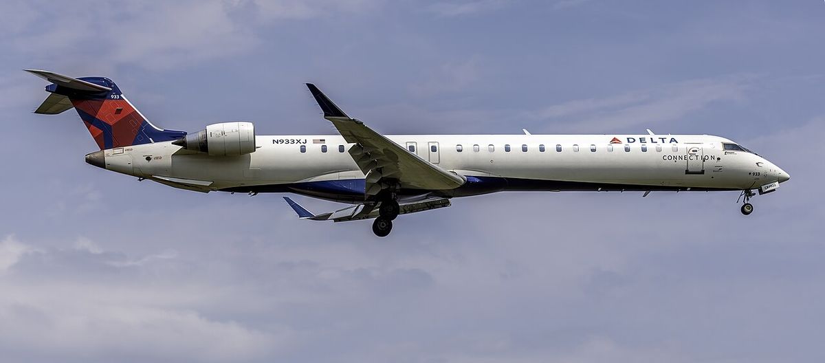 A Delta Connection CRJ-900 flown by Endeavor Air landing, with its gear down.