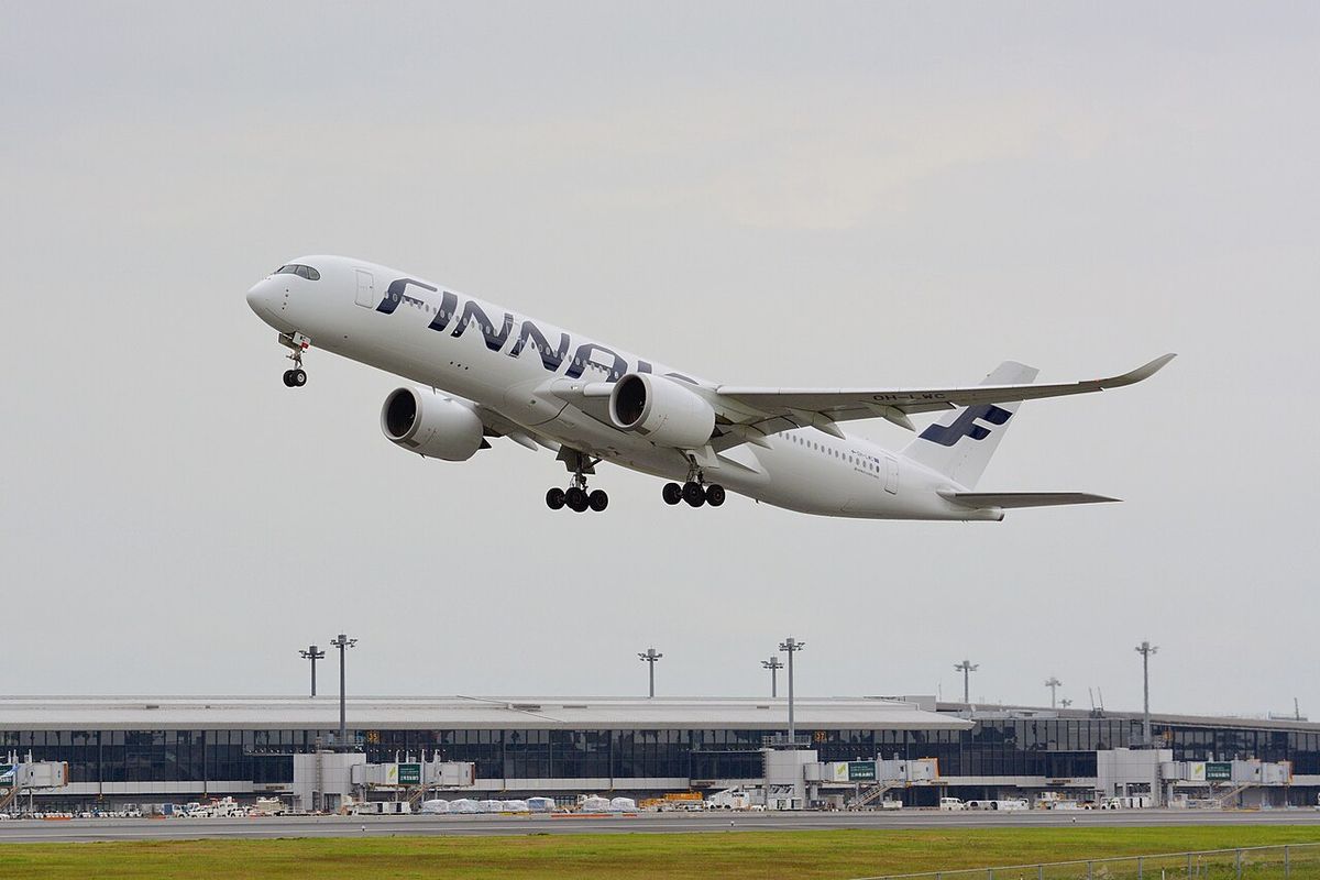 A Finnair Airbus A350-900 in its white livery with the blue tail climbing away after takeoff.