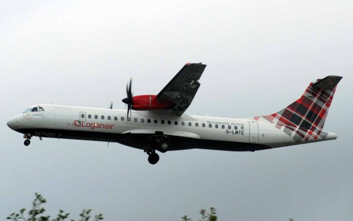 A Loganair ATR 72 turboprop with a tartan tail and red engine nacelles, landing with its gear down.