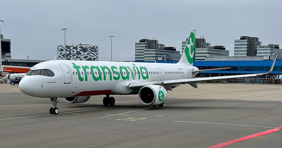 A Transavia Airbus A321neo in its white livery with the green Transavia lettering and tail, taxiing.